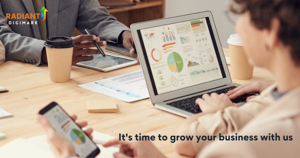 Team analyzing marketing data and performance charts on laptop — representing Radiant DigiMark’s result-driven digital marketing approach